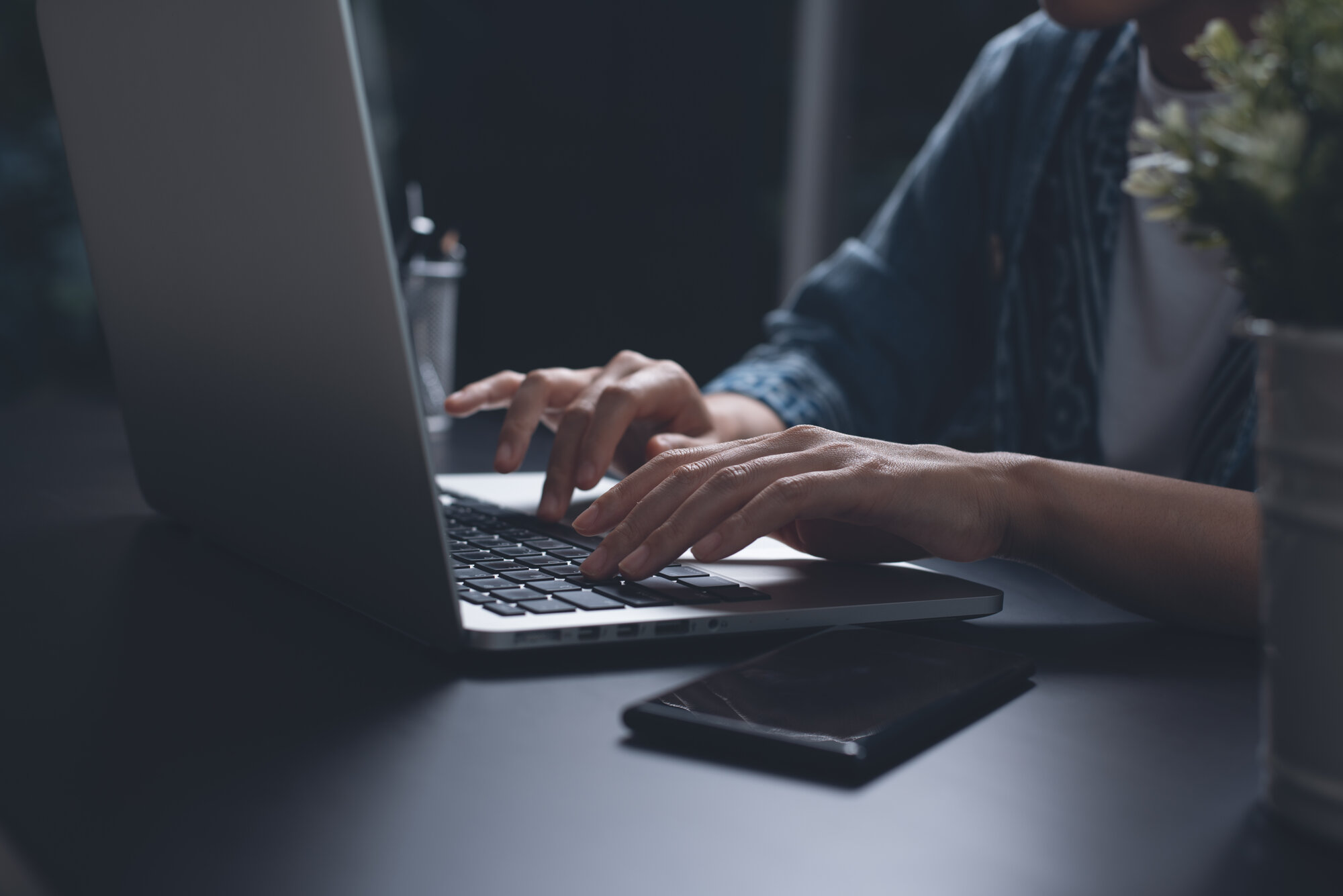 Business woman typing on laptop computer